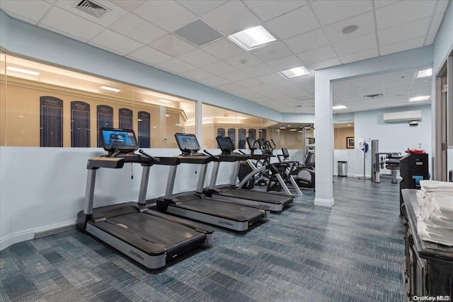 workout area with dark colored carpet, a paneled ceiling, and a wall mounted AC