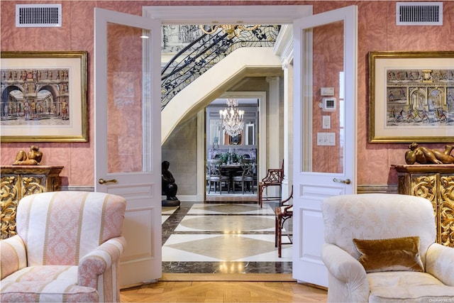 interior space with light parquet flooring and a notable chandelier