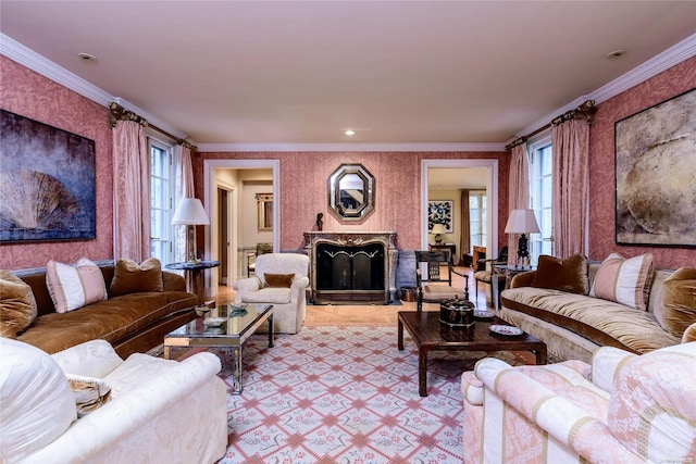 living room with a premium fireplace, crown molding, and a wealth of natural light