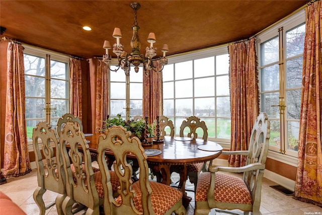 tiled dining room with a water view, french doors, a wealth of natural light, and a chandelier