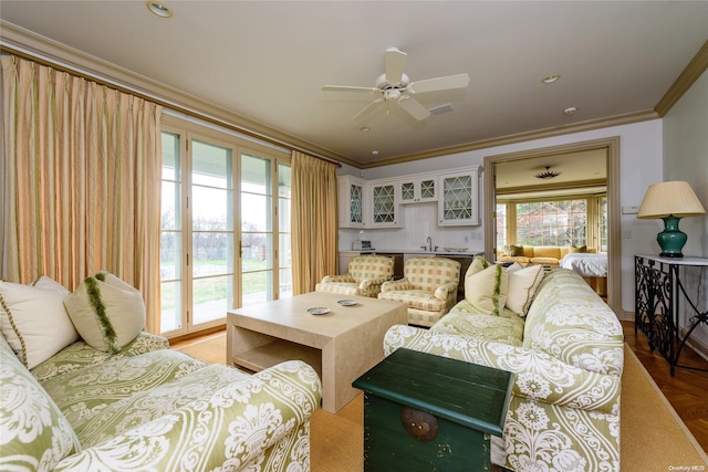 living room featuring ceiling fan and crown molding