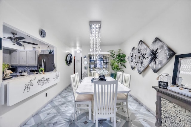 dining room featuring ceiling fan with notable chandelier