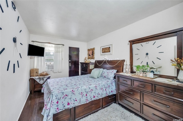 bedroom with dark wood-type flooring