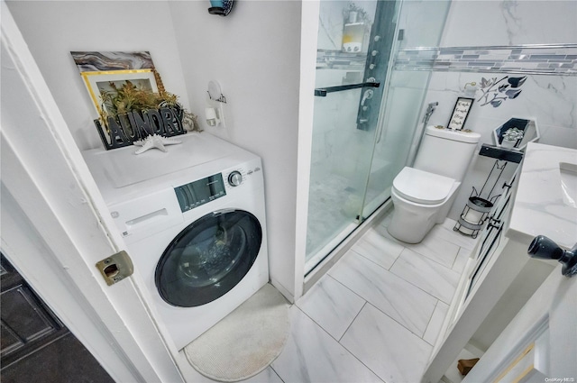 laundry area with tile walls and washer / dryer