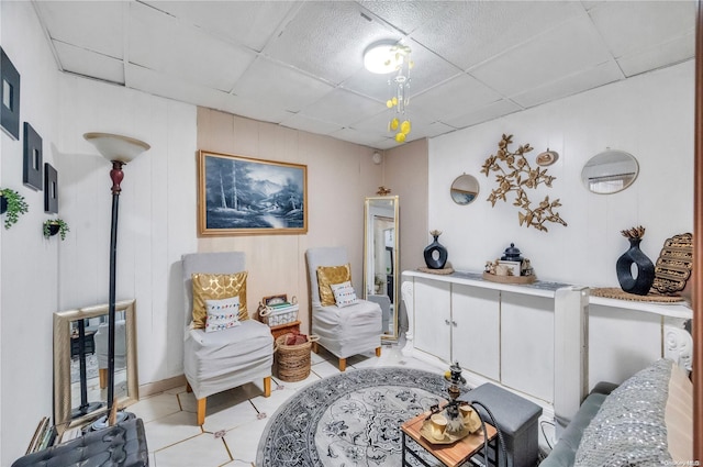 living room with a paneled ceiling