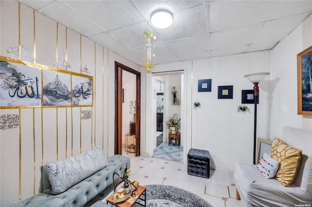 living room featuring a drop ceiling