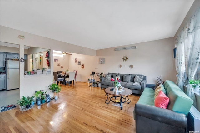 living room with ceiling fan and hardwood / wood-style floors