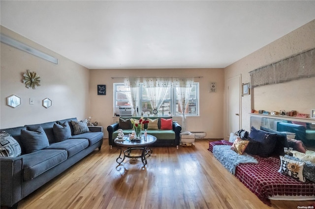 living room with cooling unit and hardwood / wood-style flooring