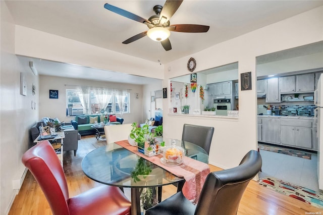 dining space featuring ceiling fan and light hardwood / wood-style flooring