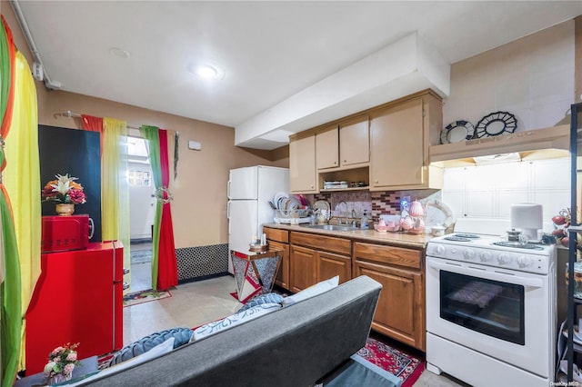 kitchen with tasteful backsplash, sink, and white appliances