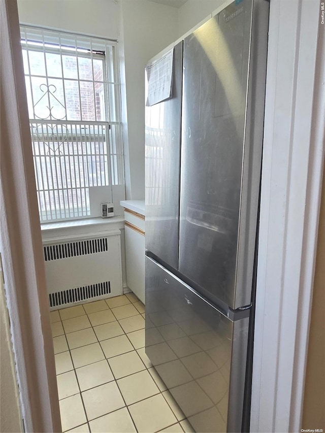 interior space with radiator heating unit and tile patterned floors