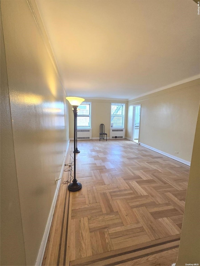 65-41 Booth St Unit 6K, Rego Park, NY 11374 - empty room featuring baseboards, crown molding, and radiator heating unit