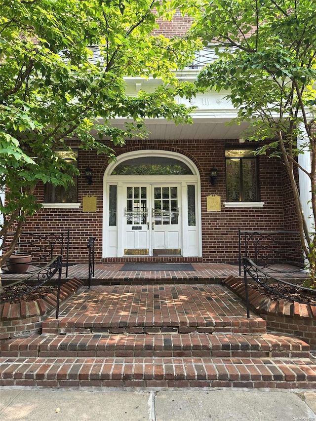 65-41 Booth St Unit 6K, Rego Park, NY 11374 - property entrance featuring french doors, brick siding, and a porch