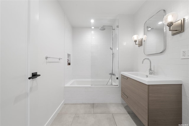 bathroom with tile patterned floors, vanity, and tiled shower / bath