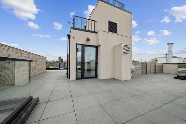 back of house with a balcony and a patio