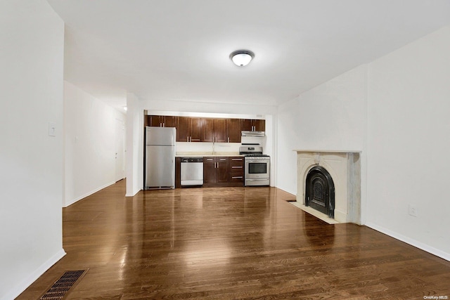 unfurnished living room featuring dark hardwood / wood-style flooring