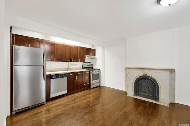 kitchen featuring stainless steel appliances, dark hardwood / wood-style floors, and sink