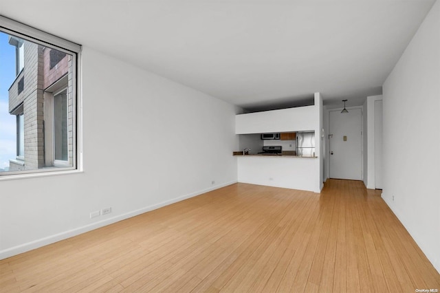 unfurnished living room with light hardwood / wood-style flooring and ceiling fan