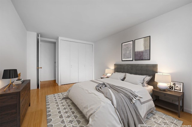 bedroom with light hardwood / wood-style flooring and a closet