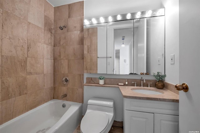 full bathroom with vanity, toilet, and tiled shower / bath