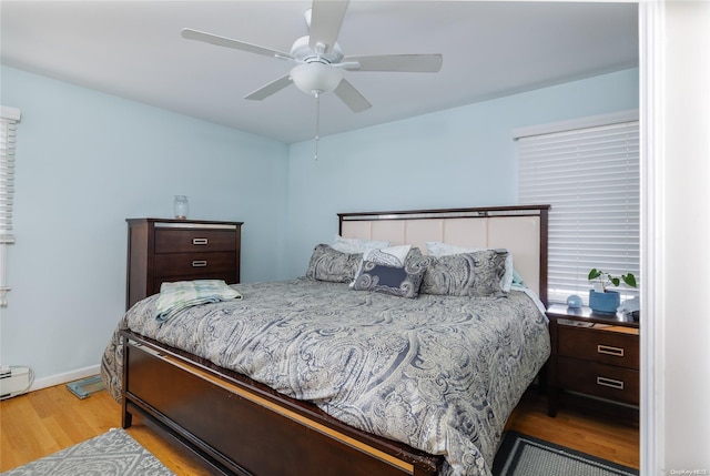 bedroom with ceiling fan and light hardwood / wood-style flooring