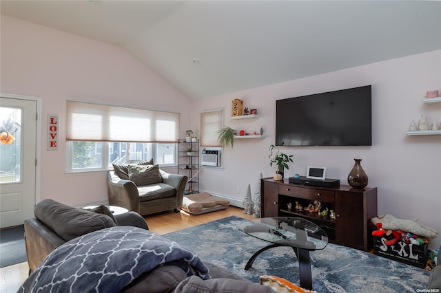 living room with light hardwood / wood-style flooring, lofted ceiling, and a wall unit AC