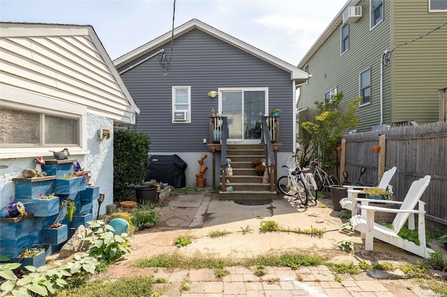 rear view of house featuring a wall mounted AC