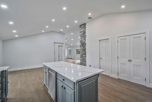 kitchen featuring visible vents, a kitchen island, gray cabinetry, and dark wood finished floors