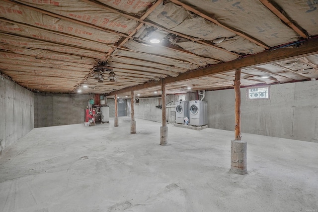 below grade area featuring gas water heater and washer and dryer