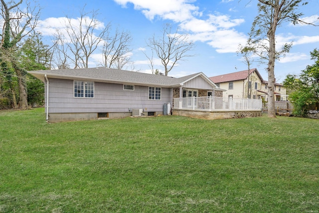 rear view of property with a yard and central AC