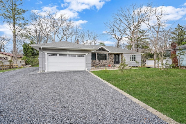 single story home featuring fence, gravel driveway, a front lawn, an attached garage, and a chimney