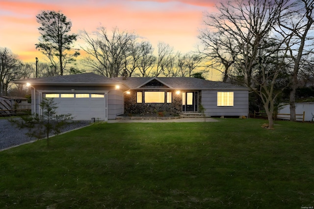 single story home with a front yard, an attached garage, fence, and driveway