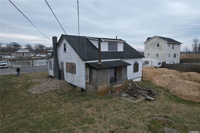 rear view of property with a yard