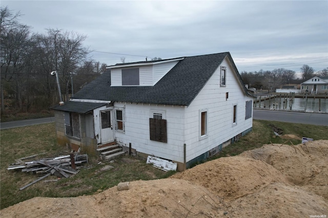 view of front of house with a water view