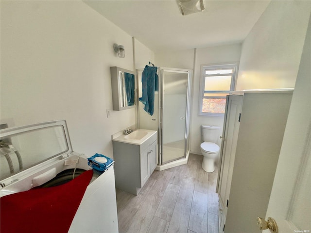 56 Woodcliff Trl, Baiting Hollow, NY 11933 - bathroom with toilet, wood finished floors, a stall shower, and vanity