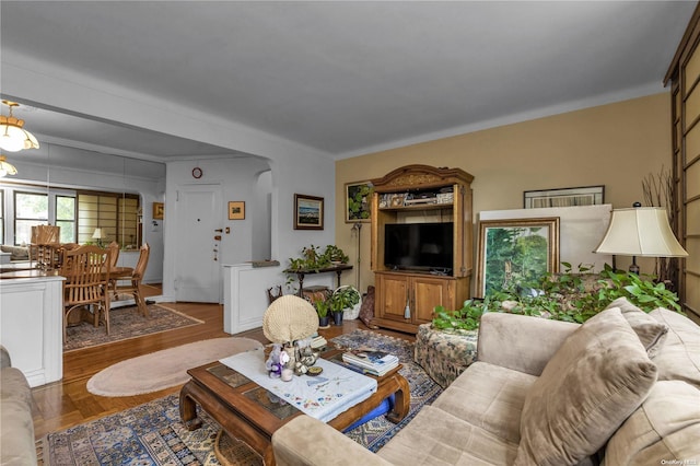 living room featuring hardwood / wood-style flooring and ornamental molding