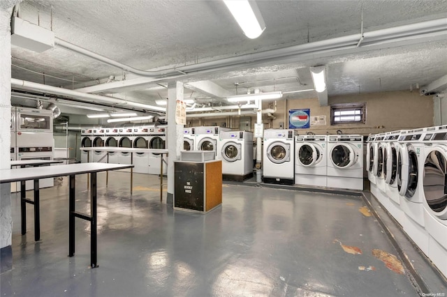 washroom with independent washer and dryer and a textured ceiling