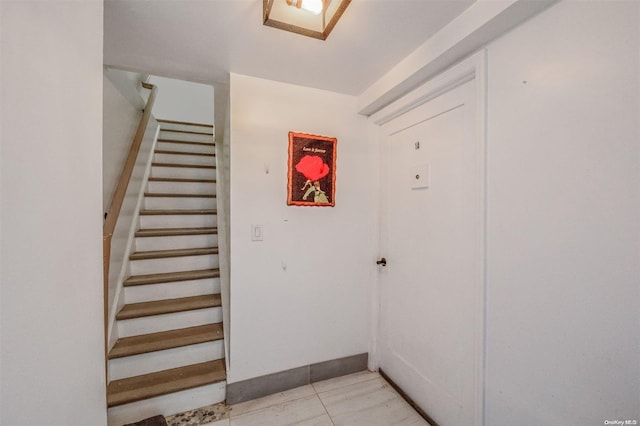 staircase with tile patterned flooring