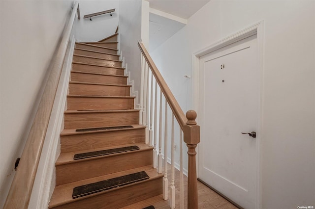 stairs with hardwood / wood-style floors