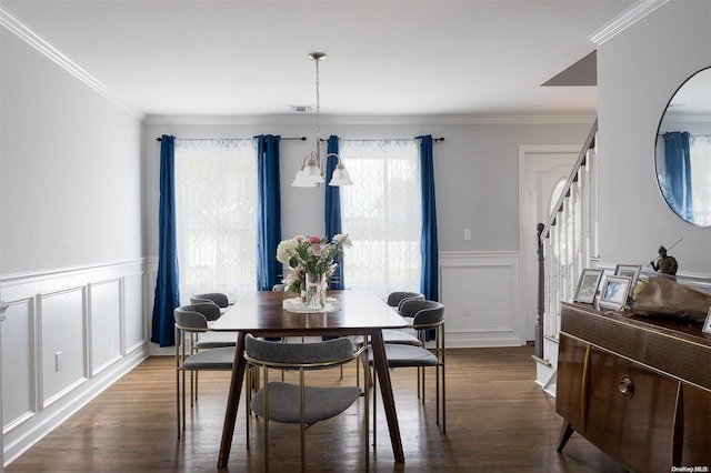 dining space featuring ornamental molding, dark wood-type flooring, and a chandelier