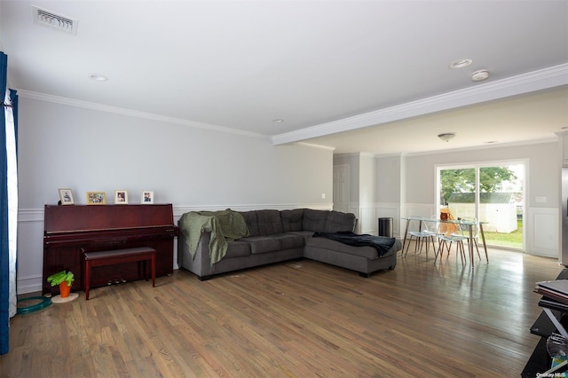 living room with hardwood / wood-style floors and crown molding