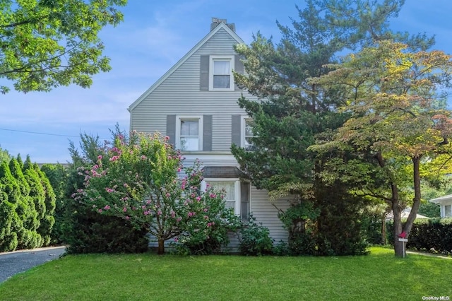 view of property exterior featuring a lawn