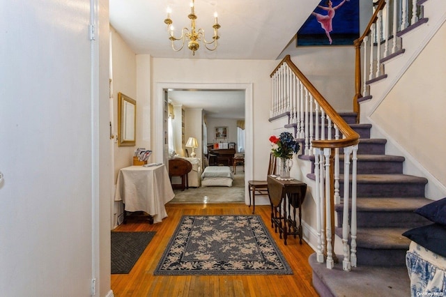 entryway featuring a notable chandelier and hardwood / wood-style flooring