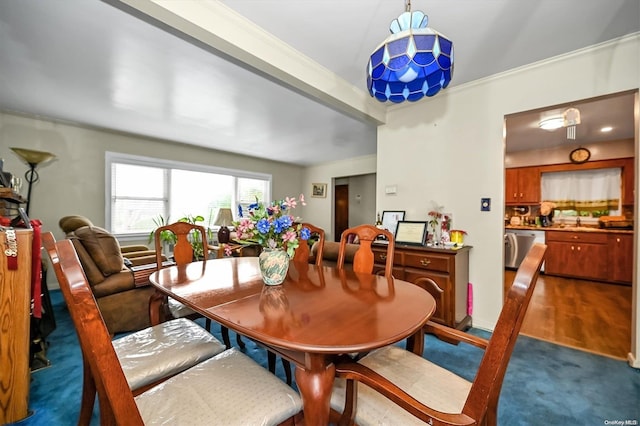 dining room with carpet and ornamental molding