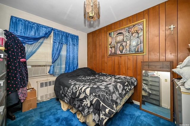 carpeted bedroom with radiator and wooden walls