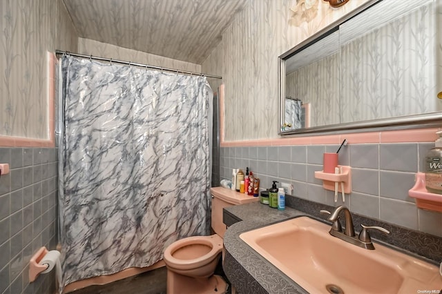 bathroom featuring toilet, tile walls, walk in shower, and vanity