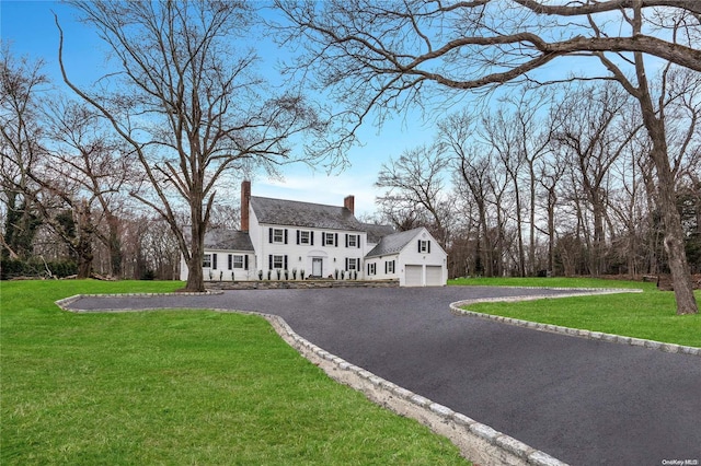 view of front of property with a garage and a front lawn