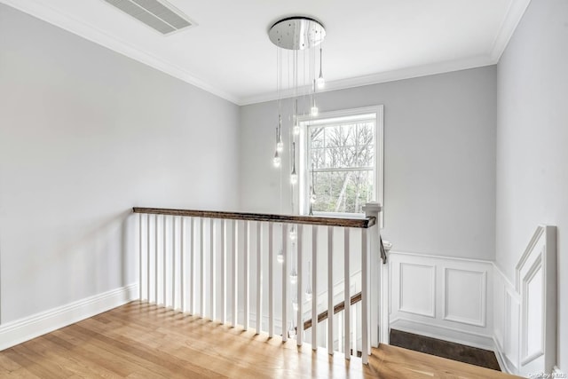 staircase featuring crown molding and hardwood / wood-style flooring