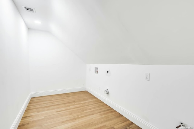 additional living space featuring light hardwood / wood-style floors and lofted ceiling