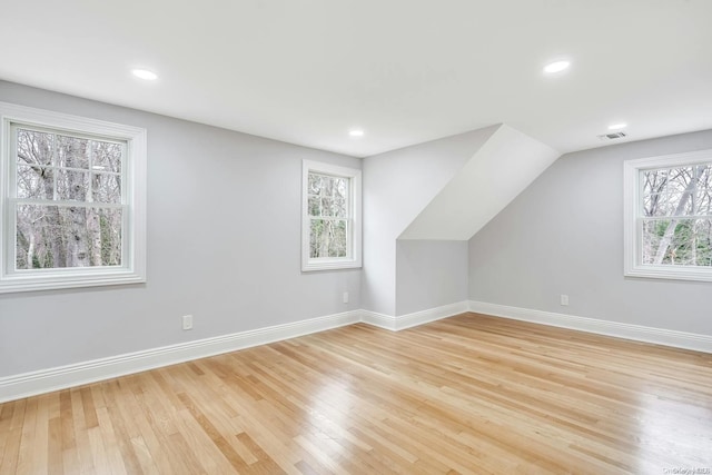 bonus room with light hardwood / wood-style flooring